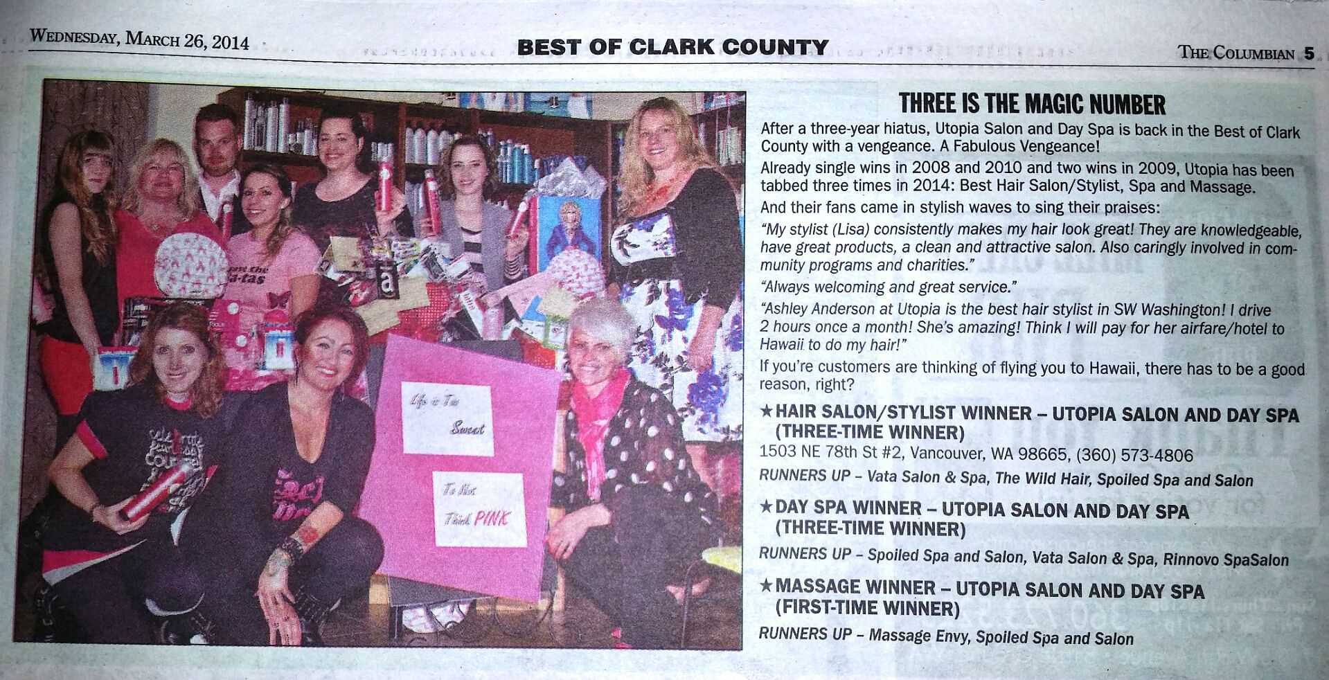 Group photo of salon staff celebrating their awards, holding certificates and smiling proudly.